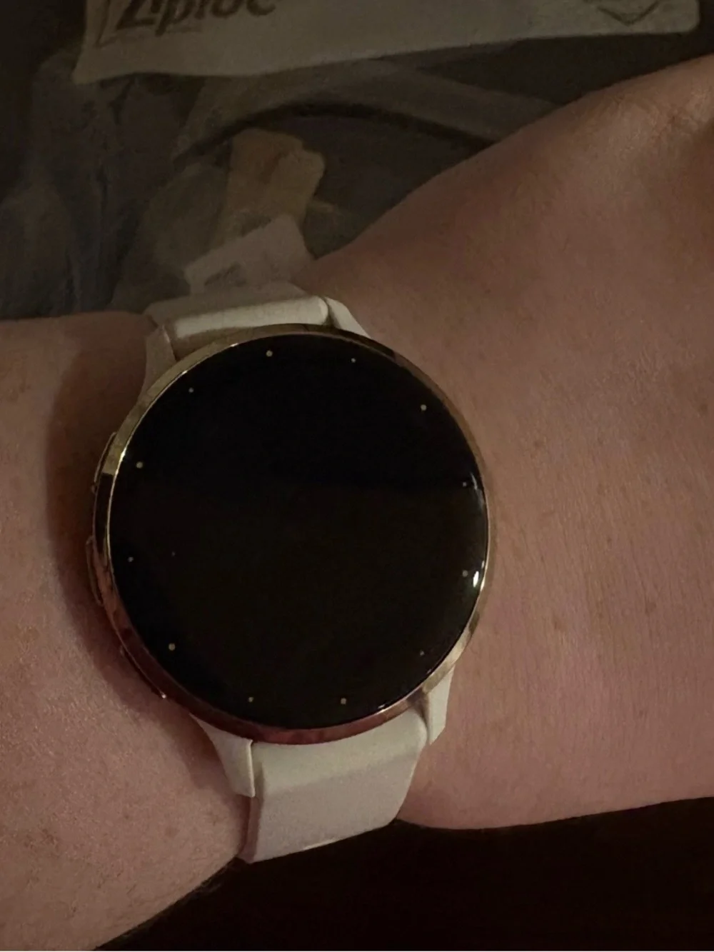 garmin white smartwatch with beige, blush, teal, mauve and black silicone bands